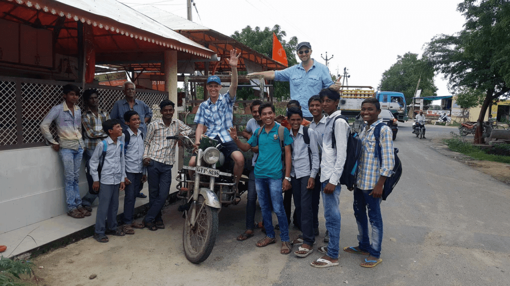 Ron on a motorbike in a crowd in India