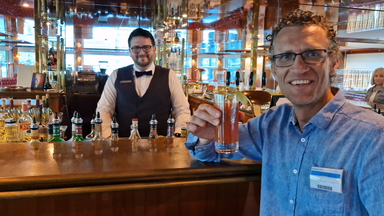 Ron Montgomery having a drink in the bar aboard the Uniworld Joie de Vivre